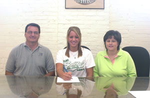 Celina's Kinsey Schumann, center, announced that she will be playing softball at the University of St. Francis next year. Seated alongside Kinsey are her parents Phil and Kay.<br></br>dailystandard.com