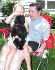 Mark Post, 36, spends a quiet moment with his 3-year-old niece, Josie Grabau, and her dog at his parents' farm in rural Celina. Post, who is mentally handicapped, was recently evicted from an area nursing home, which left his parents struggling to find an appropriate facility to care for him.<br></br>dailystandard.com