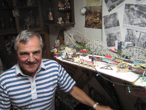 Dennis Long stands before his model replica of the former Indian Lake Playland in Russells Point. The park, which operated from 1924 to 1975, was one of Long's favorites. The lot now is covered with condos. Long's model was made to scale and includes all of the former park's rides, including the swings, which on Long's model spin through use of a battery.<br></br>dailystandard.com