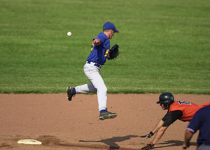 Coldwater's Tony Harlamert, right, slides into second base as St. Marys' Doug Burke, left, can't make a play on the ball that sails into centerfield during the fifth inning of their ACME district tournament contest at Hanover Street Park on Thursday. It was a suspended game due to weather from Wednesday and Coldwater went on to win it, 7-1. <br></br>dailystandard.com