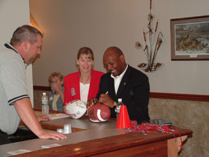 Ohio State football great Archie Griffin signs a football at Romer's Westlake in Celina on Wednesday. The two-time Heisman Trophy winner was in Celina on Wednesday to speak during a program sponsored by Mercer Health and the Community Sports and Therapy Center.<br></br>dailystandard.com