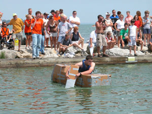 Ryan Snyder of Celina paddles his way to victory during the third annual Cardboard Duck Tape Boat Race held Saturday afternoon during the Celina Lake Festival. Snyder and his brother, Jason, took first place and were honored for their accomplishment with a ride on a parade float Saturday night.  <br></br>dailystandard.com