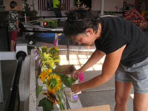 Laurie and John Settlage of St. Marys entered many, many varieties of fruits, vegetables and flowers at the Auglaize County Fair. Above, Laurie arranges one of her rose entries.<br></br>dailystandard.com