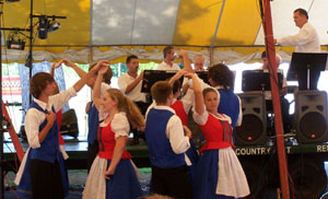 Members of the Lima Deutschen Tanz Zerein dance group and Lima Fest Musikanten band perform a number Friday afternoon at the Auglaize County Fair. The dance group brought 10 of its 28 student members from Lima Central Catholic. The group is in its third year of German dancing.<br></br>dailystandard.com