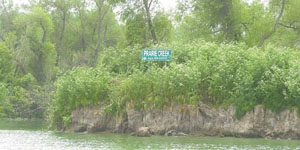 The shoreline of Prairie Creek Island in Grand Lake is quickly washing away due to wave and wind action, which puts more sediment in the lake. Lake supporters during a summit on the lake Wednesday at Wright State University-Lake Campus said more money is needed for shoreline protection.<br></br>dailystandard.com