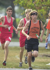 Coldwater's Dusty Kuess, front, leads the St. Henry pair of Doug Ranly, left, and Dan Rex, back right, during the Division II-III race of the Rotary Invitational on Saturday at the Wright State University-Lake Campus. Kuess was second with the Redskins' pair taking third and fourth.<br></br>dailystandard.com