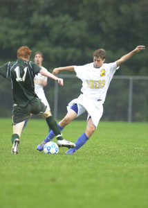 Celina's Brian Dorsten, 11, plays aggressive defense on St. Marys' Zach Albert, 2, during their Western Buckeye League contest on Thursday night. The Bulldogs won the soggy affair, 2-0.<br></br>dailystandard.com