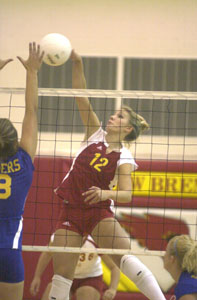 New Bremen's Christine Schwartz, 12, spikes the ball around St. Marys' Emily Shellabarger, 8, during their nonconference match on Tuesday night. New Bremen defeated St. Marys in three games.<br></br>dailystandard.com