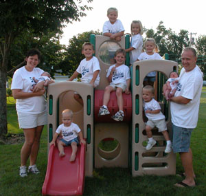 The John and Jamie Schmiesing family of Minster pose with their nine children, including a third set of twins, Frank and Rose, born Aug. 15. The other children from oldest to youngest are Alice and Emma, 6; Sam, 5; Grace, 3; Mary and John, 2, and Charlie, 1.<br></br>dailystandard.com