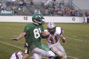 Celina's Stu Amstutz, 81, is brought down by a pair of Van Wert defenders during their Western Buckeye League contest on Friday night. Amstutz caught a pair of touchdowns to help lead the Bulldogs to a 32-0 win over the Cougars.<br></br>dailystandard.com