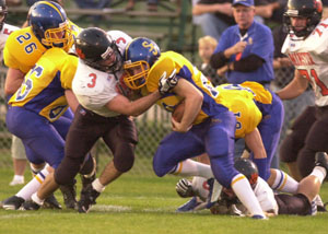 Minster's Alex Monnin, 3, comes in to make a tackle on Delphos St. John's running back Aaron Etzkorn, with ball, during their Midwest Athletic Conference football game on Saturday night. Minster fell one drive short falling to St. John's, 26-21.<br></br>dailystandard.com