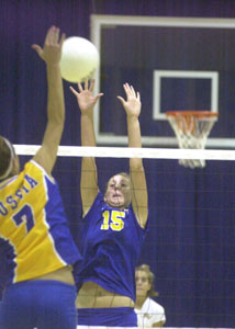 Marion Local's Abby Niekamp, 15, tries to block Russia's Hillary Monnin, 7, during their volleyball match on Monday. The Flyers defeated the Raiders in three games.<br></br>dailystandard.com