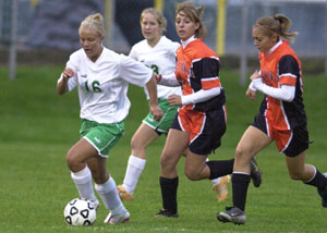 Celina's Cayla Hellwarth, 16, dribbles the ball away from the Elida defense during their Western Buckeye League contest on Tuesday night. Celina scored first, but Elida scored three unanswered goals in the final 25:45 to get a 3-1 win.<br></br>dailystandard.com