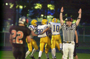 Marion Local's Dan Moeller, left, Damon Bertke, 88, and Travis Klosterman, 10, celebrate with teammate Greg Gehret, back, after Gehret caught a 52-yard touchdown reception in the first quarter against Minster on Friday night. Marion Local cruised past Minster, 27-2.<br></br>dailystandard.com