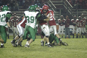 Celina's Aaron Hart, 39, comes up to make a tackle on Kenton quarterback Dailyn Campbell, right, during their Western Buckeye League contest on Friday. Kenton defeated Celina, 43-13.<br></br>dailystandard.com