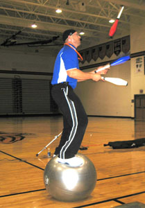 Jim Steffen, who calls himself America's fun fitness coach, talks to families at Minster Middle School on Wednesday night about the importance of healthy eating and regular exercise. He uses the exercise ball for a strenuous Boga program.<br></br>dailystandard.com