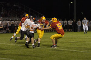 Minster's Brian Mueller, 22, tries to ward off New Bremen's Brian Ahrns, 52, during their Auglaize County matchup on Friday night. Minster overcame a 6-0 deficit with plenty of offfense as the Wildcats downed the Cardinals, 45-13.<br></br>dailystandard.com