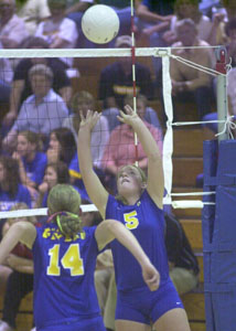 Marion Local's Heidi Elking, 5, sets the ball for teammate Kim Droesch, 14, during the Flyers' match against Fort Loramie on Monday night. After beating two state-ranked teams over the weekend, the Flyers won this one handily in three games.<br></br>dailystandard.com