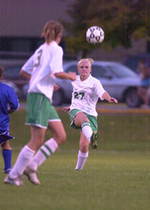 Celina's Kylie Temple, 27, kicks the ball ahead to teammate Jess Walls, 3, during their Western Buckeye League girls soccer match on Tuesday night at the Soccer Stadium. Celina wrapped up the home portion of its schedule with a 3-0 victory over Defiance.<br></br>dailystandard.com