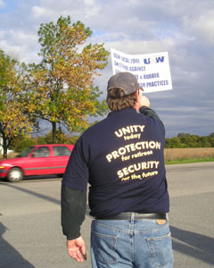 An unidentified worker holds a sign Thursday at the St. Marys plant, which has 360 active employees and more than 200 on layoff. All are expected to picket at various times during scheduled four-hour shifts. <br></br>dailystandard.com