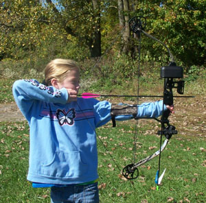 Rachel Pugh, 9, top left, and her sister, Sierra, 11, both of Fort Recovery shoot compound bows with Ohio Department of Natural Resources employee Kurt Koschalk, 25, of Wapakoneta. The three were practicing at the new archery range at the St. Marys State Fish Hatchery.<br></br>dailystandard.com