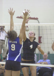 Celna's Lindsay Scheer, 4, tries to hit the ball past a Defiance player during their volleyball match on Tuesday night. Celina defeated Defiance in three games.<br></br>dailystandard.com