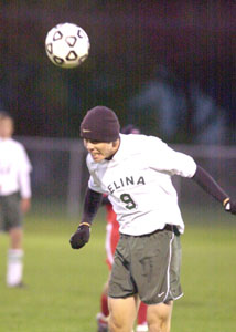 Celina's Andy Sell heads the ball to a teammate during the Bulldogs' Western Buckeye League finale on Thursday night against Wapakoneta. Celina clinched second place in the WBL following the 3-0 victory over Wapakoneta.<br></br>dailystandard.com