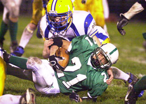 Anna ballcarrier Bryant Bensman, 21, is taken down by Marion linebacker Greg Koesters during Friday's game at Anna.<br></br>dailystandard.com