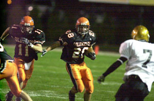 Coldwater sophomores Tony Harlamert, with ball, and Cory Klenke, 11, have made big contributions to the Cavaliers in all aspects of the game. Coldwater will look to go 10-0 in the regular season for a third straight year as St. John's comes to Cavalier Stadium on Friday for the annual 