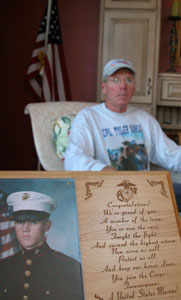 Coldwater resident Nick Kahlig is shown with a photo of his son, Tyler, a U.S. Marine who will return for another tour in Iraq next spring. Kahlig and friend, Nick Ruchty, are running in the Marine Corps Marathon in Washington, D.C., on Sunday in honor of Tyler and other military men and women. <br></br>dailystandard.com