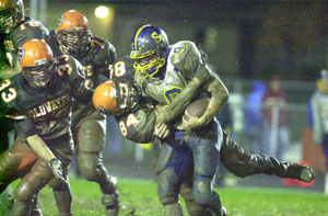 Coldwater's Adam Hoying, 84, brings down Delphos St. John's receiver Justin Klausing, 9, during their Midwest Athletic Conference contest on Friday night at Cavalier Stadium. Coldwater capped a perfect regular season with a 20-12 win over the Blue Jays.<br></br>dailystandard.com