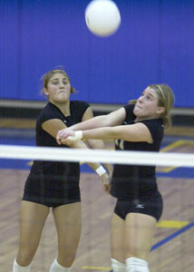 Celina's Audrey Harner, left, and Kelly Adams, right, both go after a serve during the Division II regional semfinal contest against Sunbury Big Walnut on Wednesday night at Ontario High School. Big Walnut defeated Celina in three games.<br></br>dailystandard.com