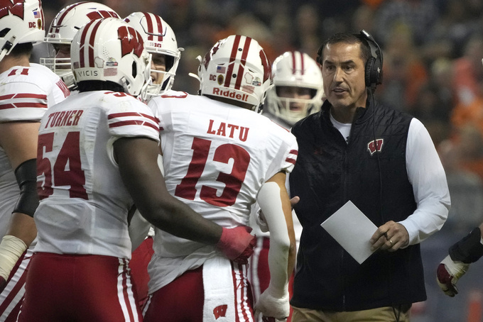 FILE - Wisconsin coach Luke Fickell celebrates with players after a touchdown during the first half of the team's Guaranteed Rate Bowl NCAA college football game against Oklahoma State, Tuesday, Dec. 27, 2022, in Phoenix. New coaches often spend their first several months dwelling on the need to instill a different culture into their programs. Fickell says the Badgers already have what he calls a “really good footprint,” something backed up by Wisconsin's 21 consecutive bowl appearances. (AP Photo/Rick Scuteri, File)
