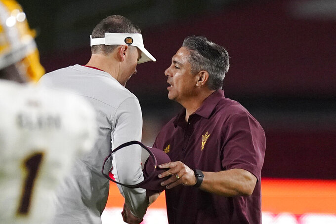 Southern California head coach Lincoln Riley, left, and Arizona State head coach Shaun Aguano shake hands after an NCAA college football game Saturday, Oct. 1, 2022, in Los Angeles. USC won 42-25. (AP Photo/Mark J. Terrill)