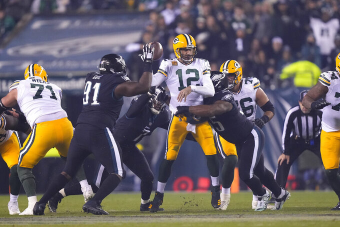 Green Bay Packers quarterback Aaron Rodgers (12) is hit during the second half of an NFL football game against the Philadelphia Eagles, Sunday, Nov. 27, 2022, in Philadelphia. (AP Photo/Matt Rourke)
