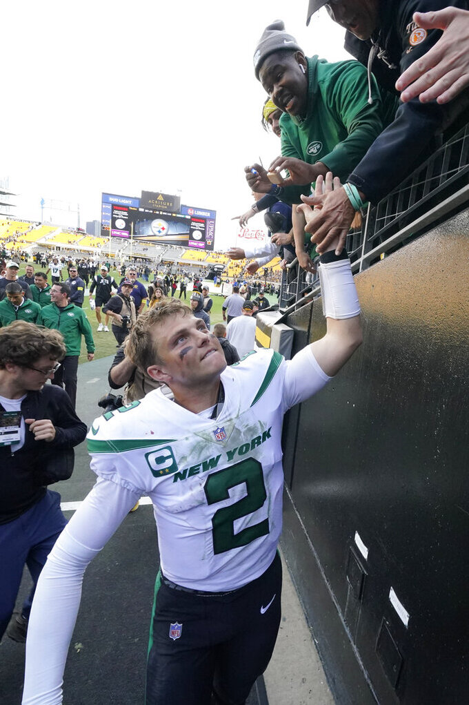 New York Jets quarterback Zach Wilson (2) greets fans as he heads to the locker room after during an NFL football game against the Pittsburgh Steelers, Sunday, Oct. 2, 2022, in Pittsburgh. (AP Photo/Gene J. Puskar)