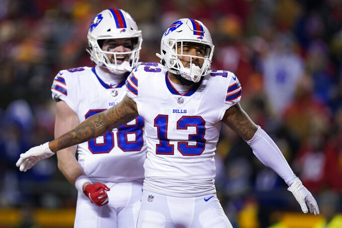 Buffalo Bills wide receiver Gabriel Davis (13) celebrates with teammate Dawson Knox (88) after catching an 18-yard touchdown pass during the first half of an NFL divisional round playoff football game against the Kansas City Chiefs, Sunday, Jan. 23, 2022, in Kansas City, Mo. (AP Photo/Ed Zurga)