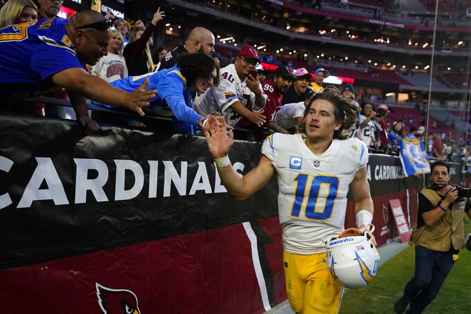 Los Angeles Chargers quarterback Justin Herbert (10) greets fans after an NFL football game against the Arizona Cardinals, Sunday, Nov. 27, 2022, in Glendale, Ariz. The Chargers defeated the Cardinals 25-24. (AP Photo/Ross D. Franklin)