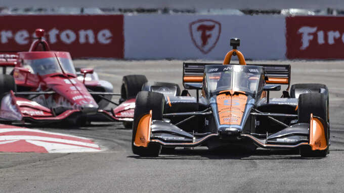 Arrow McLaren driver Pato O'Ward (car 5) leads Huski Chocolate Chip Ganassi driver Marcus Ericsson (car 8) as they steer through Turn 1 during the Grand Prix of St. Petersburg auto race Sunday, March 5, 2023, in St. Petersburg, Fla. (AP Photo/Steve Nesius)