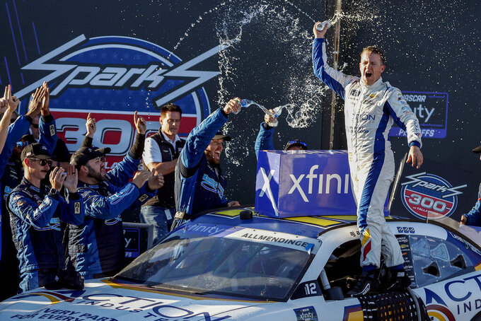 Driver AJ Allmendinger celebrates in Victory Lane after winning the NASCAR Xfinity Series auto race Saturday, Oct. 1, 2022, in Talladega, Ala. (AP Photo/Butch Dill)