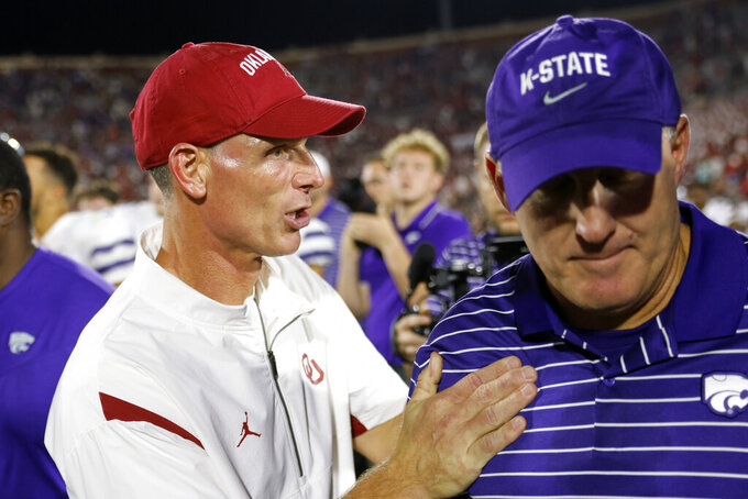 Oklahoma coach Brent Venables, left, talks to Kansas State coach Chris Klieman after an NCAA college football game Saturday, Sept. 24, 2022, in Norman, Okla. (AP Photo/Nate Billings)