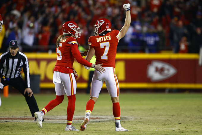 Kansas City Chiefs kicker Harrison Butker (7) celebrates with teammate Tommy Townsend (5) after kicking a 49-yard field goal during the fourth quarter of an NFL divisional round playoff football game against the Buffalo Bills, Sunday, Jan. 23, 2022, in Kansas City, Mo. The Chiefs won 42-36. (AP Photo/Colin E. Braley)