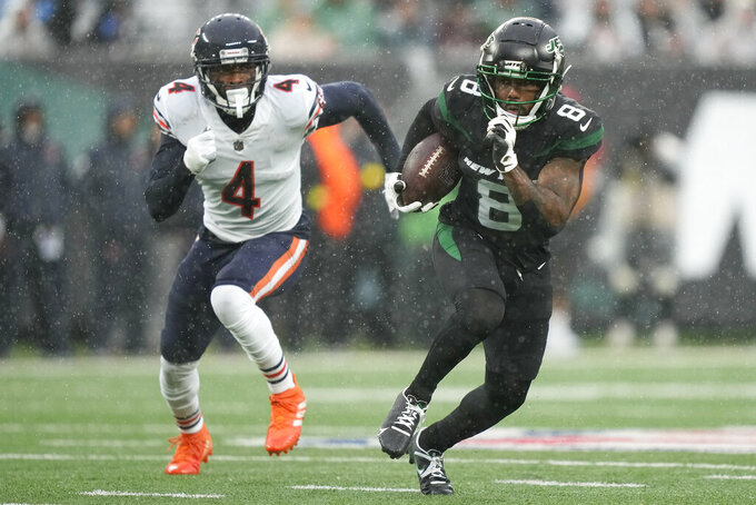 New York Jets wide receiver Elijah Moore (8) runs the ball against Chicago Bears safety Eddie Jackson (4) during the second quarter of an NFL football game, Sunday, Nov. 27, 2022, in East Rutherford, N.J. (AP Photo/John Minchillo)