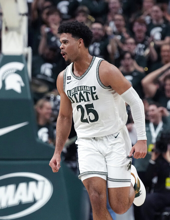 Michigan State forward Malik Hall reacts after a dunk during the first half of an NCAA college basketball game against Iowa, Thursday, Jan. 26, 2023, in East Lansing, Mich. (AP Photo/Carlos Osorio)
