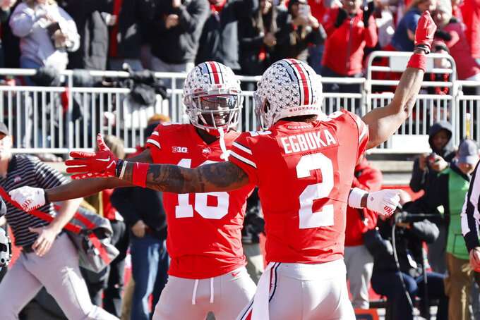 Ohio State receiver Marvin Harrison, left, celebrates his touchdown against Michigan with teammate Emeka Egbuka during the first half of an NCAA college football game on Saturday, Nov. 26, 2022, in Columbus, Ohio. (AP Photo/Jay LaPrete)