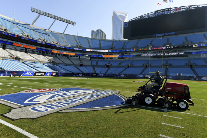 FILE -Crews prepare the field at Bank of America Stadium for the Atlantic Coast Conference championship NCAA college football game, Friday, Dec. 1, 2017. The Atlantic Coast Conference has wrapped up its spring meetings. Many discussions were held in private, including talks over how the league plans to close the financial gap with the Big Ten and the Southeastern Conference. (Diedra Laird//The Charlotte Observer via AP, File)