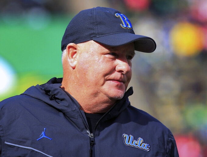 FILE - UCLA head coach Chip Kelly watches warmups before an NCAA college football game against Oregon Saturday, Oct. 22, 2022, in Eugene, Ore. Kelly has signed a two-year extension with UCLA that keeps him under contract through 2027. The school made the announcement on Friday, March 3, 2023. (AP Photo/Chris Pietsch, File)