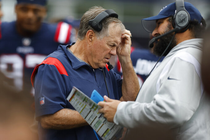 New England Patriots head coach Bill Belichick, center, scratches his head on the sidelines next to senior football advisor/offense Matt Patricia, right, in the second half of an NFL football game against the Baltimore Ravens, Sunday, Sept. 25, 2022, in Foxborough, Mass. (AP Photo/Michael Dwyer)