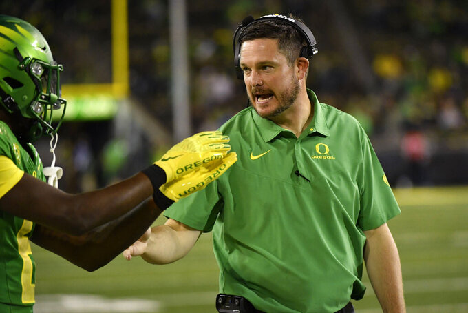 Oregon head coach Dan Lanning talks with defensive back Jahlil Florence (6) during the second half of an NCAA college football game Saturday, Oct. 1, 2022, in Eugene, Ore. (AP Photo/Andy Nelson)