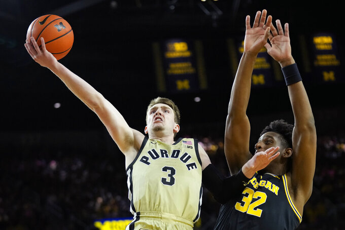Purdue guard Braden Smith (3) drives to the basket past Michigan forward Tarris Reed Jr. (32) during the first half of an NCAA college basketball game in Ann Arbor, Mich., Thursday, Jan. 26, 2023. (AP Photo/Paul Sancya)